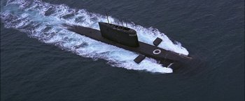 Movie still from “First Strike” (1996), directed by Stanley Tong – An aerial view of a submarine in the water; Extreme Wide shot, Overhead angle