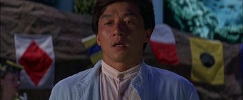 Movie still from “First Strike” (1996), directed by Stanley Tong – A person wearing a shirt; Close Up shot, Low angle