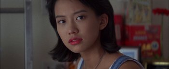 Movie still from “First Strike” (1996), directed by Stanley Tong – A person wearing a necklace; Close Up shot, High angle