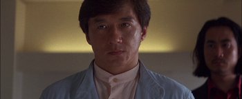 Movie still from “First Strike” (1996), directed by Stanley Tong – A person wearing a jacket; Close Up shot, Low angle