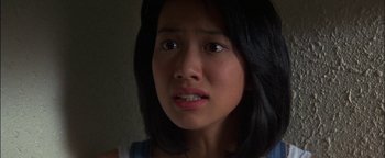 Movie still from “First Strike” (1996), directed by Stanley Tong – A person looking at the camera; Close Up shot, Low angle