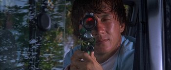 Movie still from “First Strike” (1996), directed by Stanley Tong – A man holding a camera up to his eye; Close Up shot, Low angle