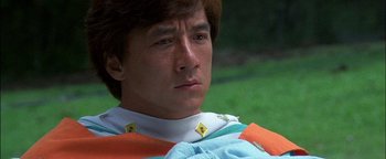 Movie still from “First Strike” (1996), directed by Stanley Tong – A person wearing a shirt; Close Up shot, Low angle