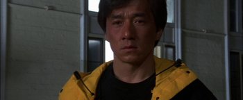 Movie still from “First Strike” (1996), directed by Stanley Tong – A person wearing a yellow raincoat; Close Up shot, Low angle