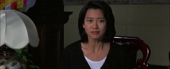 Movie still from “First Strike” (1996), directed by Stanley Tong – A person wearing a black jacket; Close Up shot, Over the shoulder angle