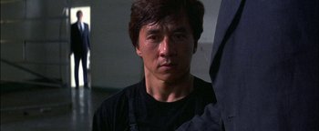 Movie still from “First Strike” (1996), directed by Stanley Tong – A person wearing a black t - shirt; Close Up shot, Low angle