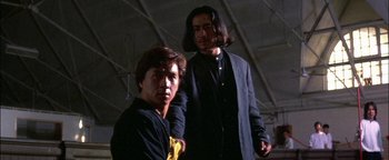 Movie still from “First Strike” (1996), directed by Stanley Tong – A man and a woman standing next to each other; Medium shot, Low angle