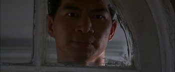 Movie still from “First Strike” (1996), directed by Stanley Tong – A man's face in a mirror; Close Up shot, Low angle