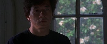 Movie still from “First Strike” (1996), directed by Stanley Tong – A person looking at the camera; Close Up shot, Low angle