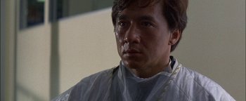 Movie still from “First Strike” (1996), directed by Stanley Tong – A person wearing a white shirt; Close Up shot, Low angle
