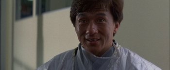 Movie still from “First Strike” (1996), directed by Stanley Tong – A person smiling for the camera; Close Up shot, Low angle