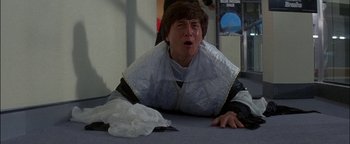 Movie still from “First Strike” (1996), directed by Stanley Tong – A man in a kimono is laying on the floor; Close Up shot, High angle