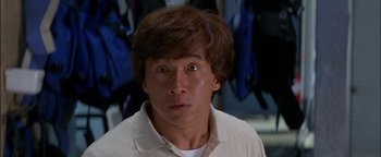 Movie still from “First Strike” (1996), directed by Stanley Tong – A person wearing a white shirt; Close Up shot, Low angle