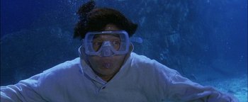 Movie still from “First Strike” (1996), directed by Stanley Tong – A man wearing a scuba mask in the water; Medium shot, High angle
