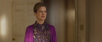 Movie still from “Poltergeist” (2015), directed by Gil Kenan – A woman in a purple outfit standing next to a wall; Close Up shot, Low angle