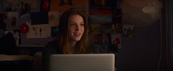Movie still from “Poltergeist” (2015), directed by Gil Kenan – A woman sitting in front of a laptop computer; Medium shot, Over the shoulder angle
