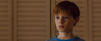 Movie still from “Poltergeist” (2015), directed by Gil Kenan – A young boy is looking into the distance; Close Up shot, Over the shoulder angle