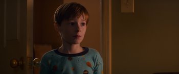 Movie still from “Poltergeist” (2015), directed by Gil Kenan – A young boy is standing in a room; Close Up shot, Over the shoulder angle