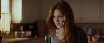 Movie still from “Poltergeist” (2015), directed by Gil Kenan – A beautiful young woman with long red hair and blue eyes; Close Up shot, Over the shoulder angle