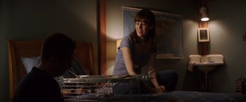 Movie still from “Poltergeist” (2015), directed by Gil Kenan – A woman sitting on the ground in a room; Medium shot, Over the shoulder angle