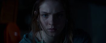 Movie still from “Poltergeist” (2015), directed by Gil Kenan – A person wearing ear phones; Close Up shot, Low angle