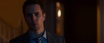 Movie still from “Poltergeist” (2015), directed by Gil Kenan – A person wearing a suit and tie; Close Up shot, Over the shoulder angle