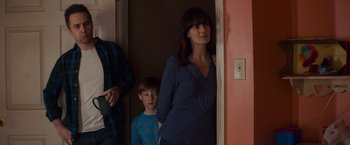 Movie still from “Poltergeist” (2015), directed by Gil Kenan – A woman standing next to a boy in a room; Medium shot, Over the shoulder angle