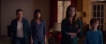 Movie still from “Poltergeist” (2015), directed by Gil Kenan – Two women standing next to each other in front of a window; Medium shot, Over the shoulder angle