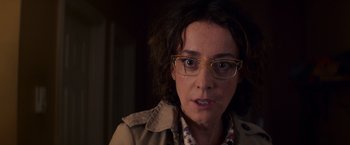 Movie still from “Poltergeist” (2015), directed by Gil Kenan – A person wearing glasses and a jacket; Close Up shot, Over the shoulder angle
