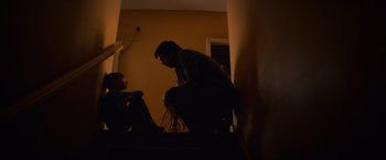 Movie still from “Poltergeist” (2015), directed by Gil Kenan – A man sitting on top of a bed next to a woman; Medium shot, Low angle