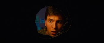 Movie still from “Poltergeist” (2015), directed by Gil Kenan – A young man looking through a hole in the wall; Close Up shot, Overhead angle