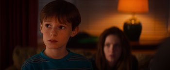 Movie still from “Poltergeist” (2015), directed by Gil Kenan – A boy and a woman are looking at the camera; Close Up shot, Over the shoulder angle