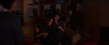 Movie still from “Poltergeist” (2015), directed by Gil Kenan – Two women sitting on a couch in a living room; Medium shot, High angle
