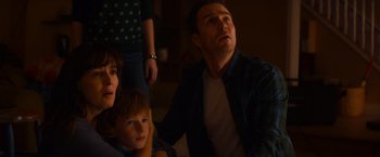 Movie still from “Poltergeist” (2015), directed by Gil Kenan – A man and a woman and a child looking up at the sky; Medium shot, Low angle
