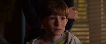 Movie still from “Poltergeist” (2015), directed by Gil Kenan – A young boy with a towel around his neck; Close Up shot, High angle