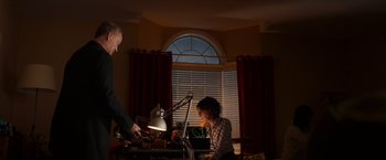 Movie still from “Poltergeist” (2015), directed by Gil Kenan – A man and a woman sitting at a table in front of a laptop; Medium shot, Low angle