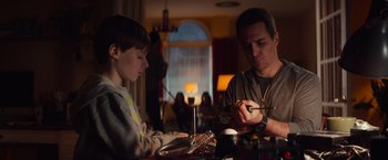 Movie still from “Poltergeist” (2015), directed by Gil Kenan – A man and a boy sitting at a table; Medium shot, Low angle