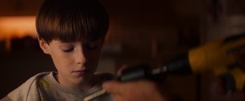 Movie still from “Poltergeist” (2015), directed by Gil Kenan – A boy is looking at a cell phone; Close Up shot, Over the shoulder angle