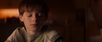 Movie still from “Poltergeist” (2015), directed by Gil Kenan – A young boy with his eyes closed and his head turned to the side; Close Up shot, Low angle