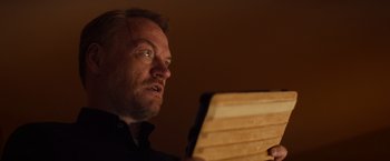 Movie still from “Poltergeist” (2015), directed by Gil Kenan – A person holding a tablet; Close Up shot, Low angle