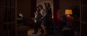 Movie still from “Poltergeist” (2015), directed by Gil Kenan – A group of people standing in a living room holding remotes; Wide shot, Low angle