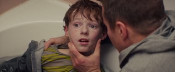 Movie still from “Poltergeist” (2015), directed by Gil Kenan – A young boy is being examined by a doctor; Close Up shot, Over the shoulder angle
