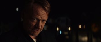 Movie still from “Poltergeist” (2015), directed by Gil Kenan – A person wearing a suit and tie; Close Up shot, Over the shoulder angle