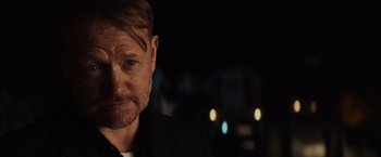 Movie still from “Poltergeist” (2015), directed by Gil Kenan – A person wearing a suit; Close Up shot, Over the shoulder angle