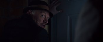 Movie still from “Poltergeist” (2015), directed by Gil Kenan – A man in a hat is looking at the camera; Close Up shot, Low angle