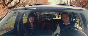 Movie still from “Poltergeist” (2015), directed by Gil Kenan – Three people in a car looking out of the window; Medium shot, Over the shoulder angle