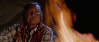 Movie still from “Poltergeist II: The Other Side” (1986), directed by Brian Gibson – An older man sitting in front of a fire; Close Up shot, Over the shoulder angle