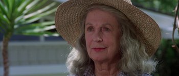 Movie still from “Poltergeist II: The Other Side” (1986), directed by Brian Gibson – An older woman wearing a straw hat and a plaid shirt; Close Up shot, Low angle