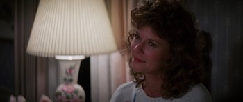 Movie still from “Poltergeist II: The Other Side” (1986), directed by Brian Gibson – A person sitting in front of a lamp; Close Up shot, Over the shoulder angle