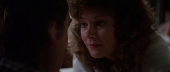 Movie still from “Poltergeist II: The Other Side” (1986), directed by Brian Gibson – A woman's face as a man looks on; Close Up shot, Over the shoulder angle